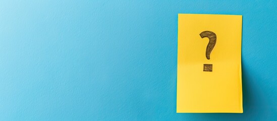 Exclamation mark or warning sign concept depicted on a yellow sticky note against a blue background with copy space image