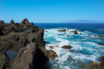Volcanic rocks at Cueva de la Vaca and the Atlantic Ocean in Santiago del Teide Tenerife Spain