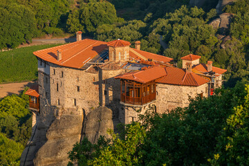 Monasteries located on unique rock formations in the Meteora region of Greece are illuminated by...