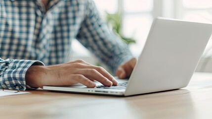 Fototapeta premium Individual Engaged in Office Work Using Laptop