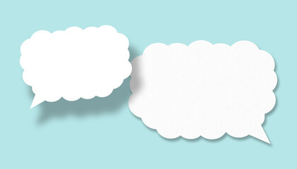 Empty white cloud paper speech bubble shape against light blue background.
