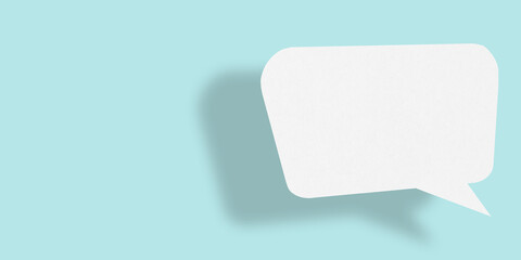 Empty speech balloon shape white paper isolated on light blue background communication bubbles.