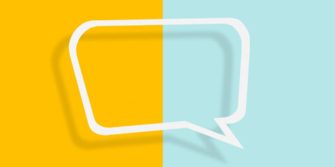 Empty transparent balloon paper speech bubble shape against yellow-light blue background.