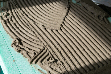 Adhesive mortar was applied onto the XPS (Extruded Polystyrene) board with a notched trowel.