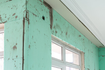 Indoor thermal insulation materials mounted on the wall of a room. XPS (Extruded Polystyrene) boards on the wall.