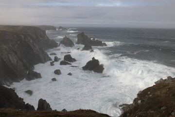 Obraz premium A rocky shoreline on the Atlantic Ocean in The Dungeon Provincial Park, Bonavista Peninsula Newfoundland and Labrador, Canada.
