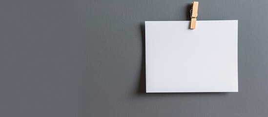 Business growth portfolio symbol displayed on a lovely white paper attached to a wooden clothespin against a stunning grey background conveying a professional image with copy space