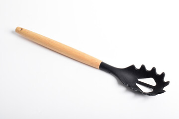 Black plastic spoon for draining of spaghetti isolated on white background