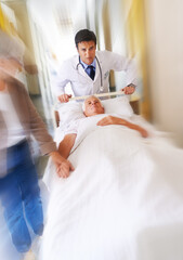 Fototapeta premium Doctor, bed and running for emergency in hospital with urgent surgery, healthcare and moving fast. Surgeon, patient and hurry for medical crisis with motion blur, accident injury and rush in clinic