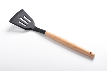 Kitchen spatula on isolated white background. Black silicone spatula with wooden handle. Cooking utensil