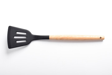 Kitchen spatula on isolated white background. Black silicone spatula with wooden handle. Cooking utensil