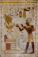 wall relief of pharaoh Seti I  offering to the god Osiris at Abydos temple.  Egypt.