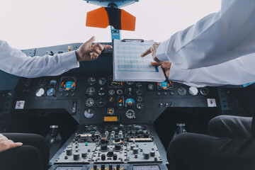 Professional pilot woman in uniform has teamwork meeting for success flight in aviation business. Young female captain instructor sitting in office and working or training commercial airline crew. © ARMMY PICCA