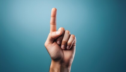 A hand with one of their fingers pointing up.