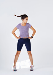 Woman, fitness and wind with workout in studio on white background on confidence and isolated. Female person, sweat and body on exercise, training and serious for health and wellness in sportswear