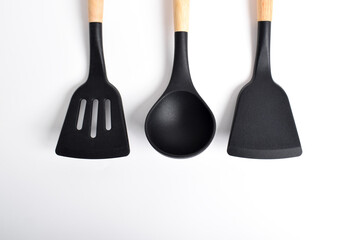 Silicone cooking utensils set with wooden handle isolated on white background. Kitchen tool sets. top view, flat lay.