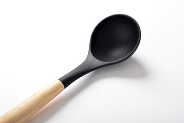 Close up Black silicone kitchen soup ladle isolated on white background. Kitchen utensils