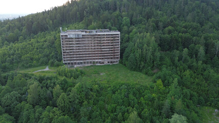 Derelict hotel surrounded by trees