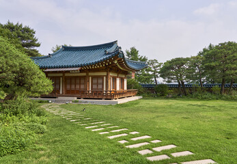 Sejong-ro, Jongno-gu, Seoul, South Korea - June 20, 2022: Summer view of stone stepping stones on grass yard and a tiled house at Blue House 