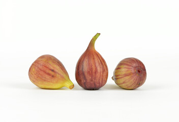 Close-up of three raw figs with two lying ones on white floor, South Korea