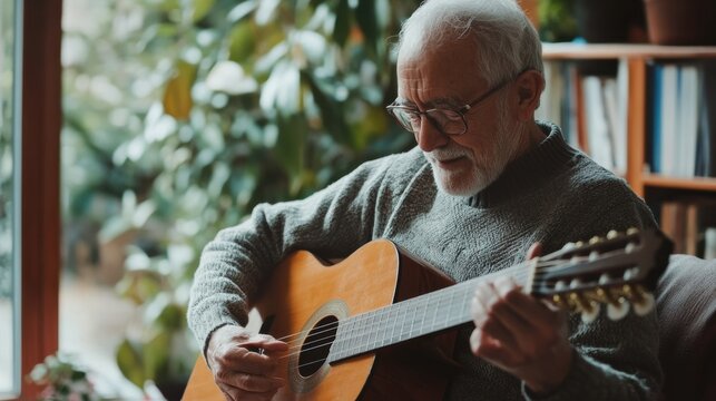 Elderly man playing guitar at home
 - Powered by Adobe