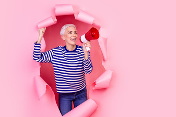 Photo of attractive lovely woman wear striped stylish clothes break paper wall announce news empty...