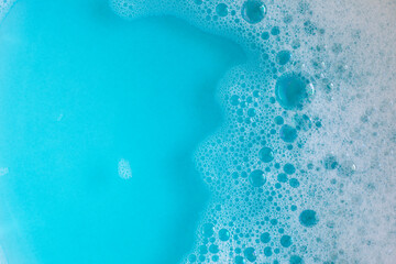 Foam in blue water. Blue foam. Water with foam bubbles. Blue background