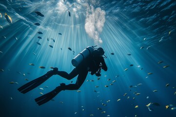 Scuba diver exploring underwater with sunlight rays