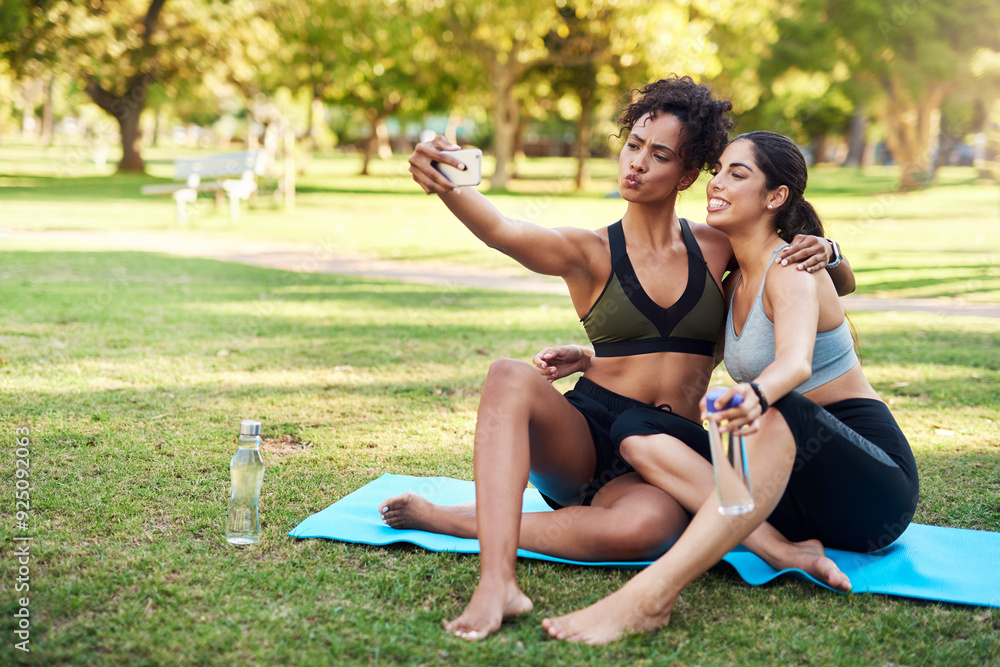 Sticker Selfie, friends and break in park, fitness and silly with funny face, grass and rest for workout in nature. Outdoor, athlete and profile picture for women, influencer or pout for post in social media