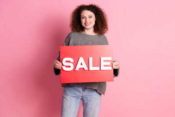 Photo portrait of lovely young lady hold sale plate banner dressed stylish gray garment isolated on...