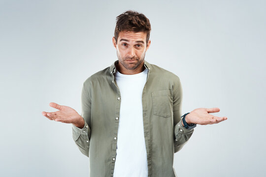 Man, portrait and confused by choice, doubt or decision in white background with hand gesture in studio. Person, option and thinking as frustrated consumer, questioning and contemplating for sale