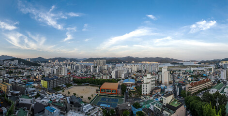 Masanhappo-gu, Changwon-si, Gyeongsangnam-do, South Korea - June A, 2022: Panoramic and high angle view of playground of a school with townhouses and apartments in summer