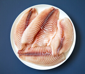 Fillet of tilapia or Saint Peter fish Oreochromis niloticus. Isolated on white background