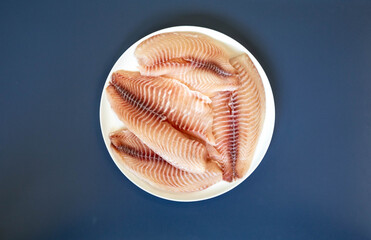 Fillet of tilapia or Saint Peter fish Oreochromis niloticus. Isolated on white background