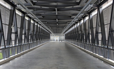 Pedestrian pathway or corridor or hallway between train station and other building.