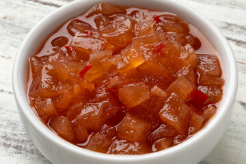 White ceramic bowl with melon chutney close up