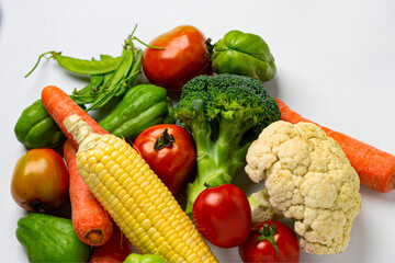 Top view of fresh vegetables on white background.