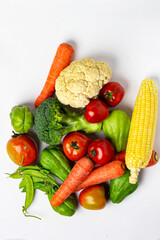 Assorted fresh vegetables on isolated white background, showing various colors and textures