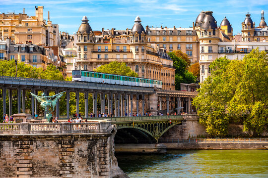 “Pont de Bir-Hakeim“ or “Pont de Passy“  is an arch bridge that crosses the Seine river in Paris (France) with 2 levels for carspedestrians and a metro line. Historic construction and touristic sight - Powered by Adobe