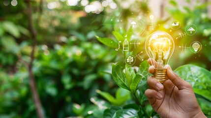A hand holding a lightbulb with sustainable icons around it, set against a backdrop of green leaves.