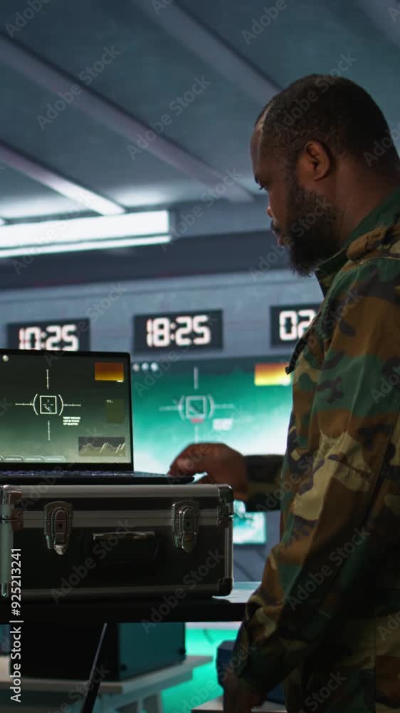 Poster vertical video air force officer performing tactical level surveillance in command room using laptop