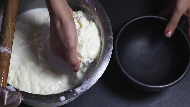 Churning of Milk cream to make white butter at home.