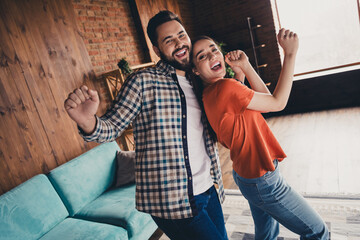 Photo of happy young couple dance celebrate holiday move new place enjoy live together have fun new apartment room light house flat indoor