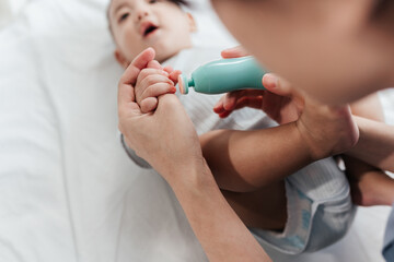 Selective focus, Mother's Hand Expertly Using Specific Tool to Cutting and Filing Baby's Nails, Ensuring Hygiene and Health. Mother Taking Care of the Baby. Selective Focus.