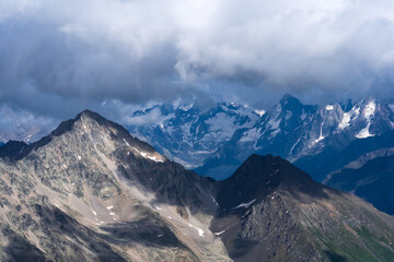 beautiful mountainous landscape, rocks and glaciers among clouds