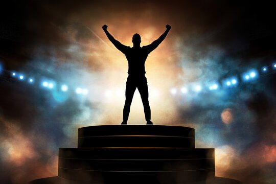 Silhouette of victorious person on stage with spotlight smoke