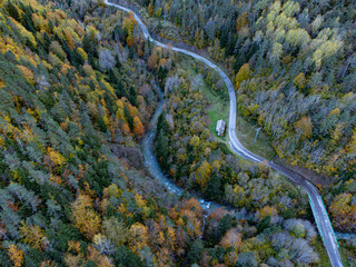 Aerial view of mountain road through a forest in autumn. Aragonese Pyrenees. Huesca. Spain