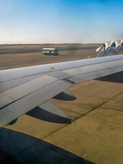 Gray steel airplane wing stands on the ground at the airport 
