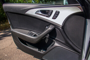 Black and gray open driver's door with buttons