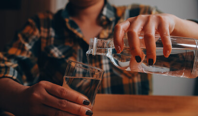 healthy beautiful young woman holding glass of water